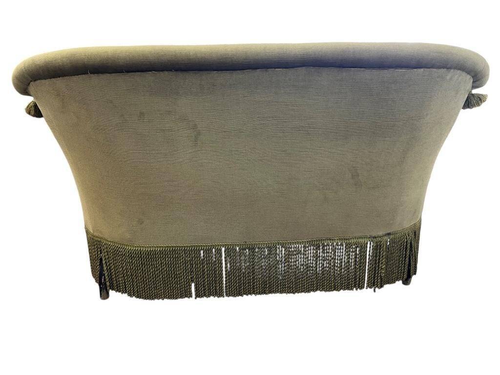 Vintage green two-seater sofa with fringes