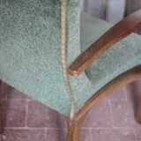 Art Deco armchair in wood and green fabric, living room armchair, interior decor.