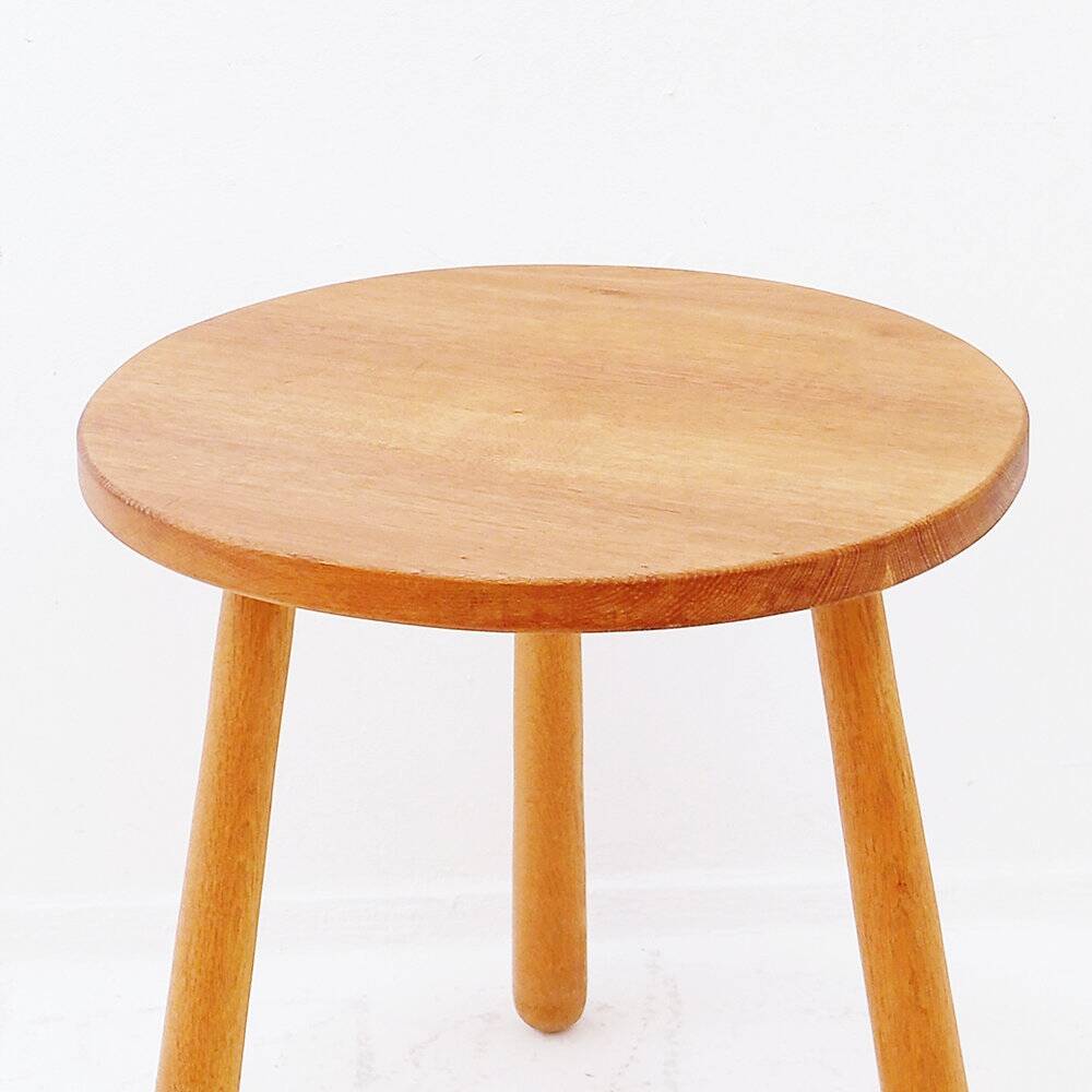 Vintage solid wood side table with rounded legs.