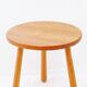 Vintage solid wood side table with rounded legs.