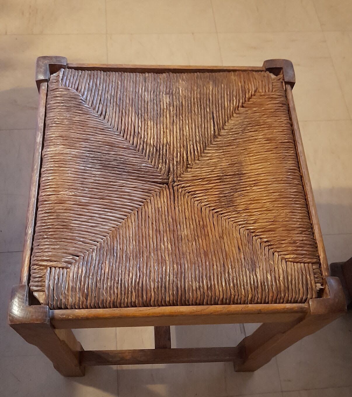 Oak stool seated in straw