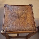 Oak stool seated in straw