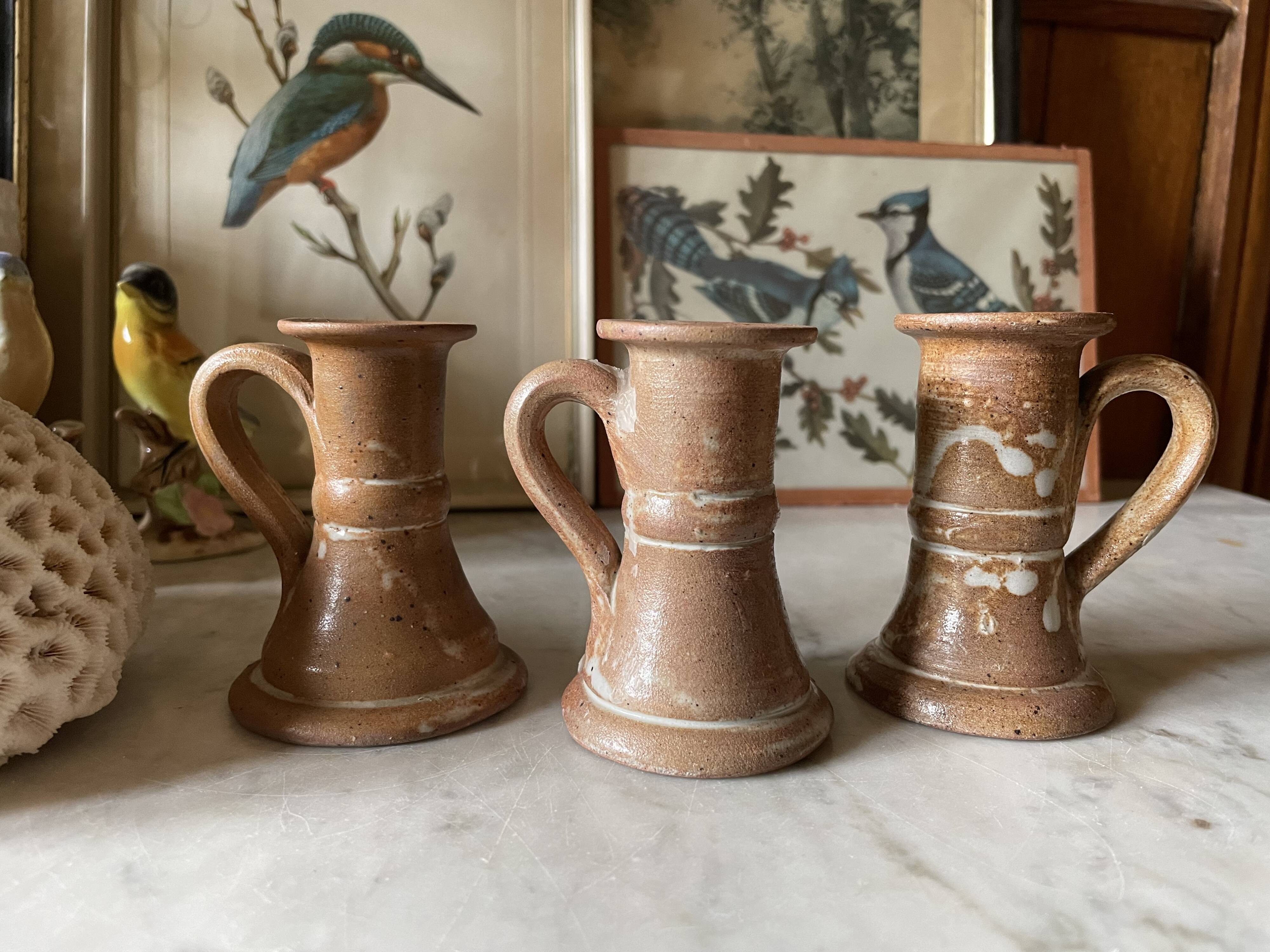 Trio of stoneware candle holders