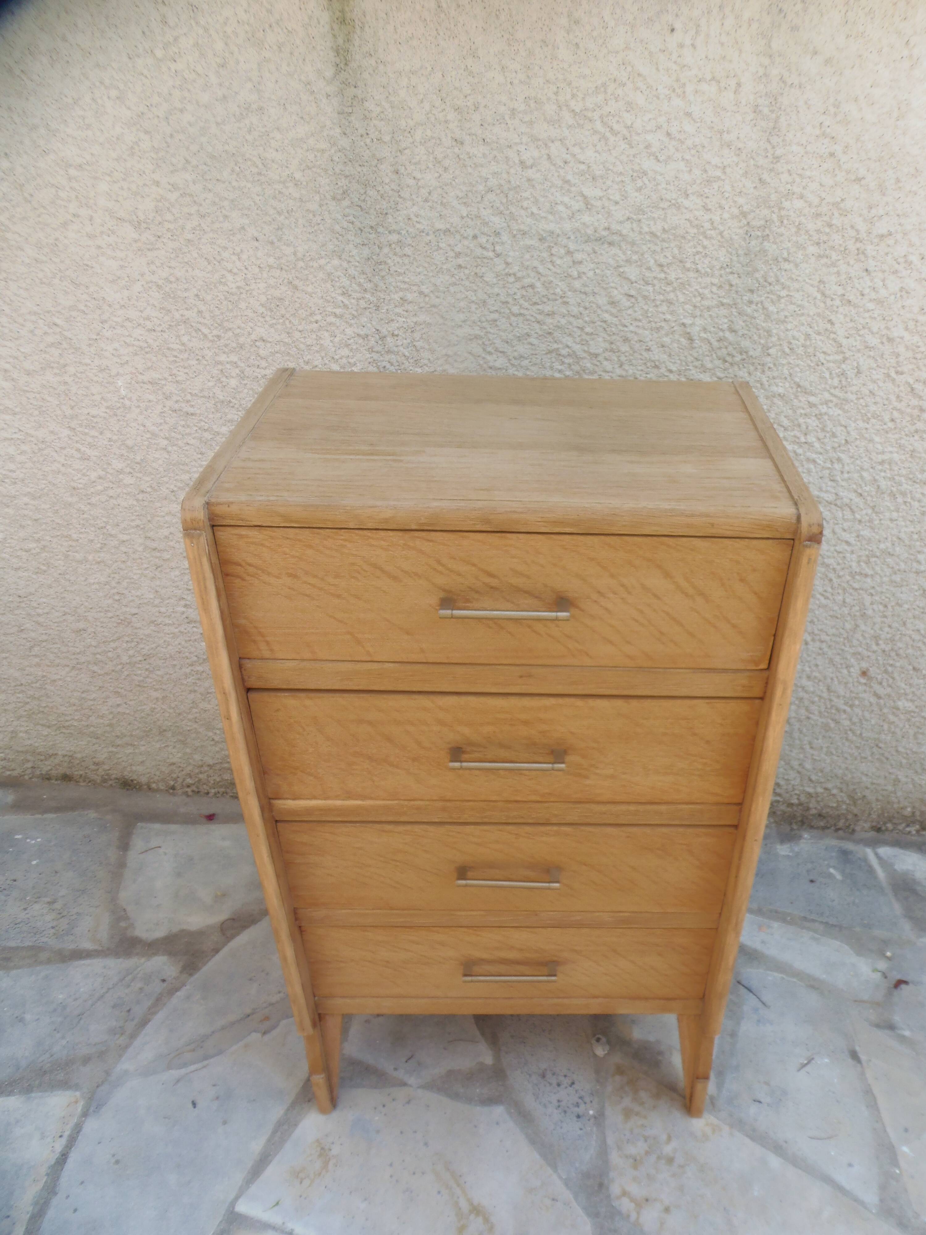 Vintage chest of drawers in raw wood.
