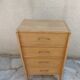 Vintage chest of drawers in raw wood.
