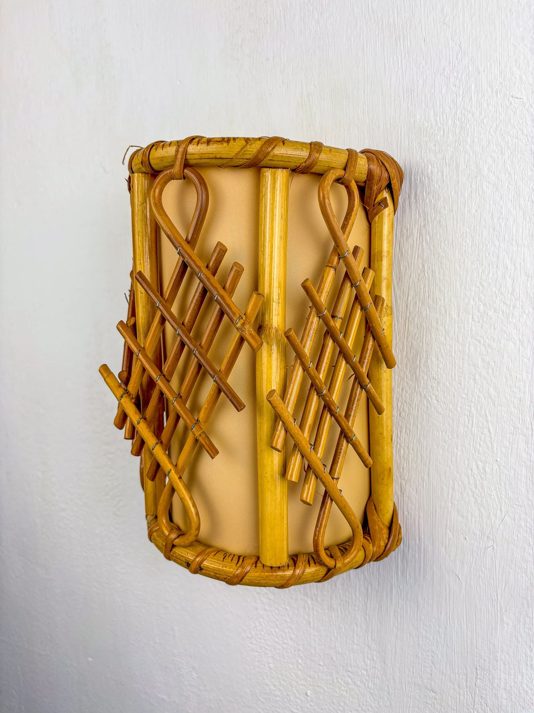 Pair of mid-century rattan wall sconces, circa 1970s, Italy