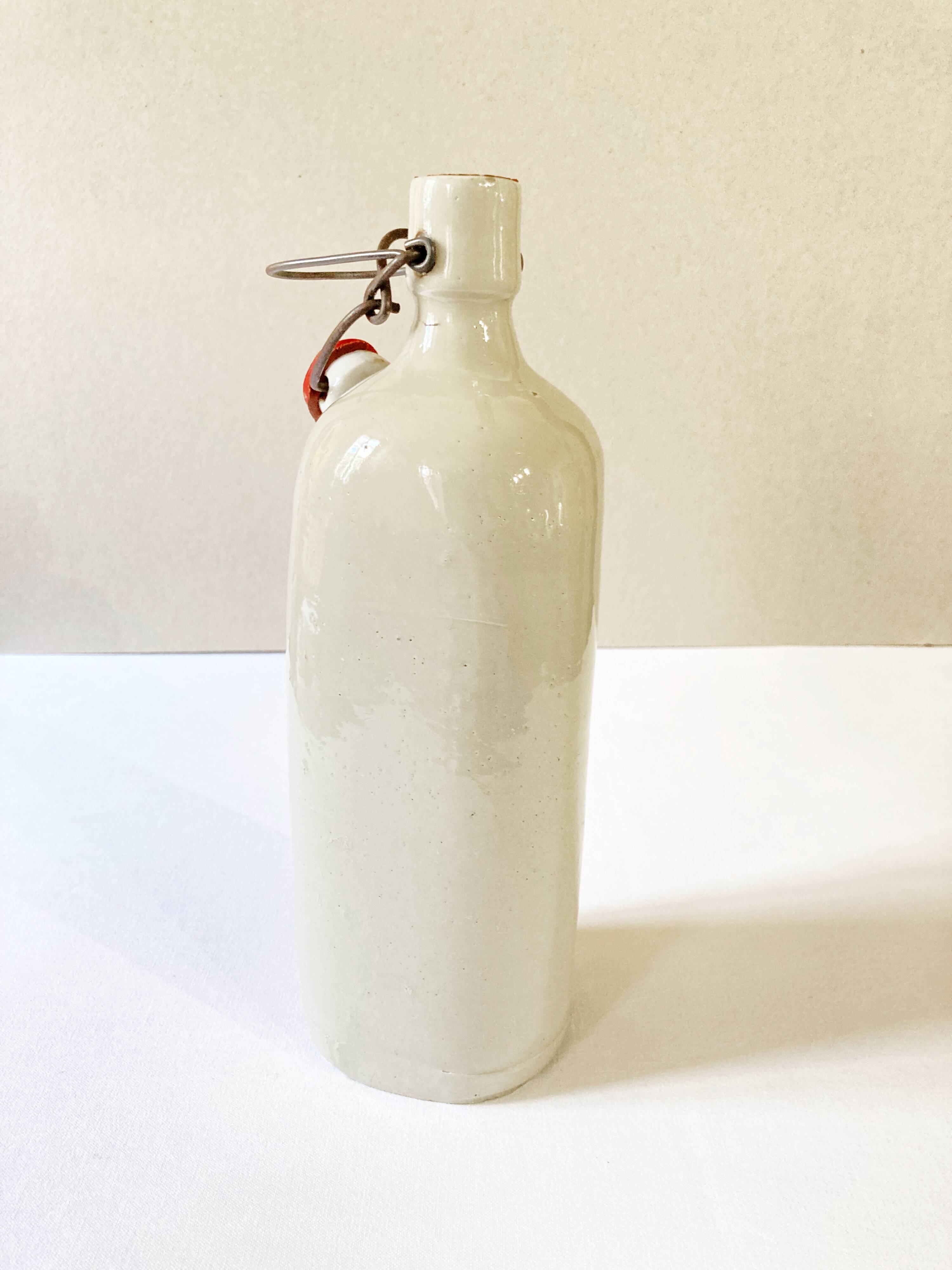 Old light gray enamelled stoneware hot water bottle
