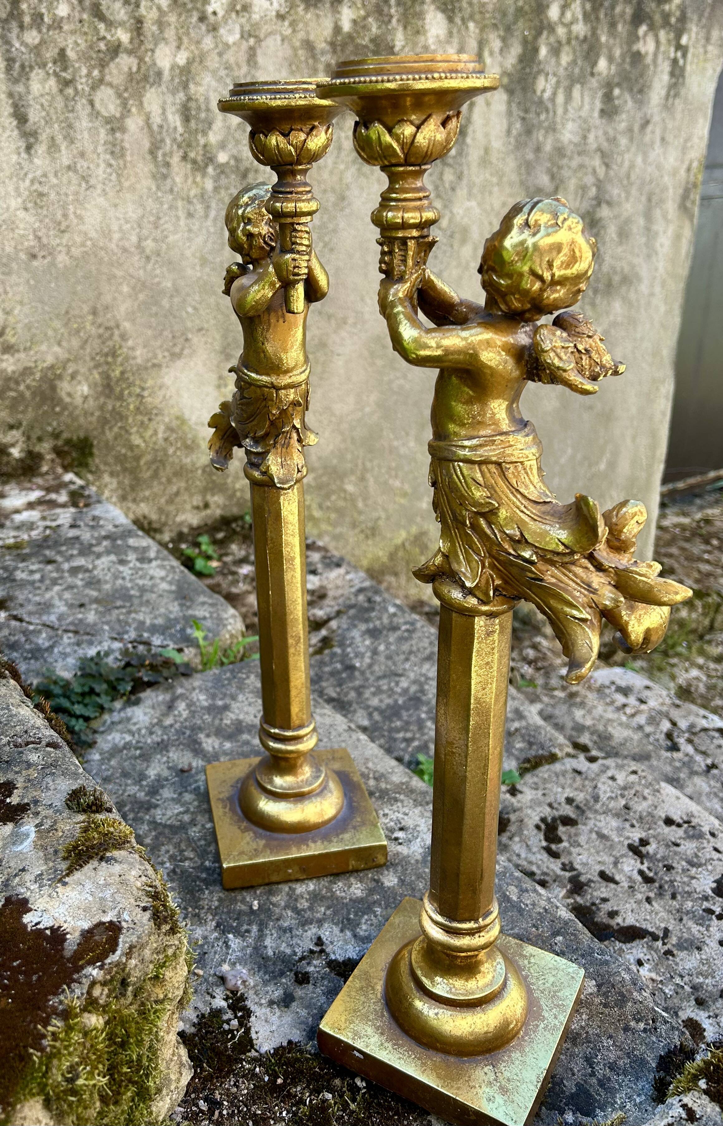 Pair of large candlesticks with cherubs