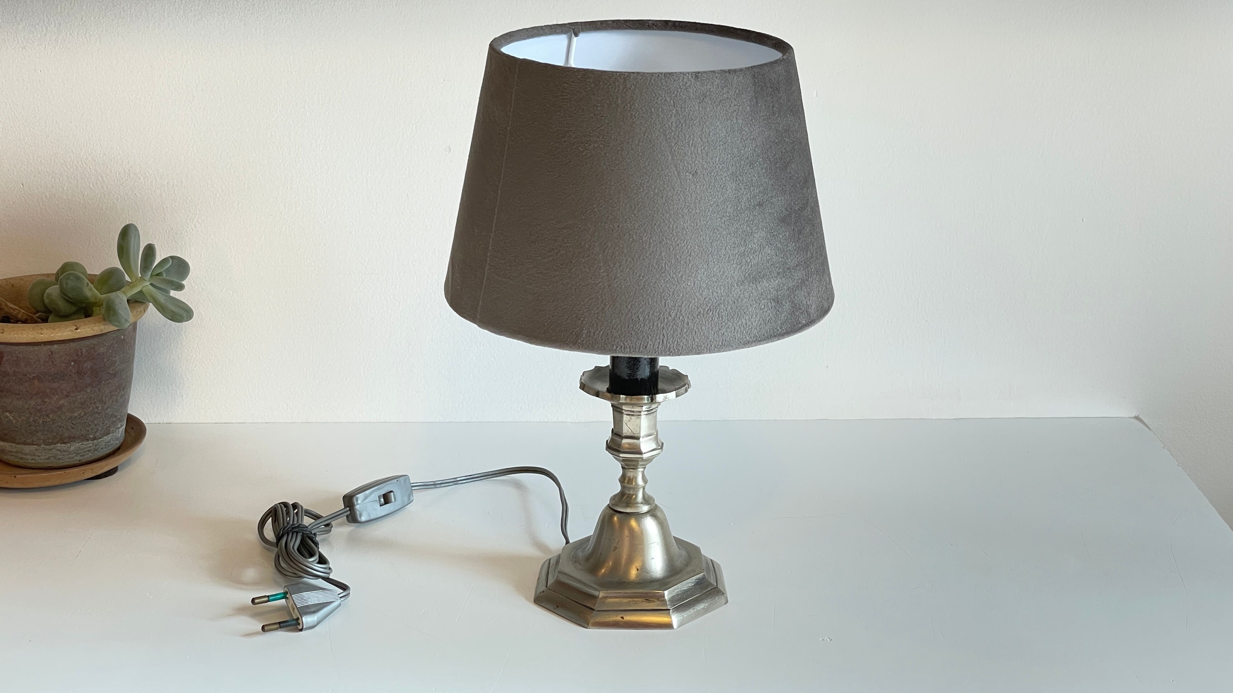 Steel candlestick lamp and grey velvet