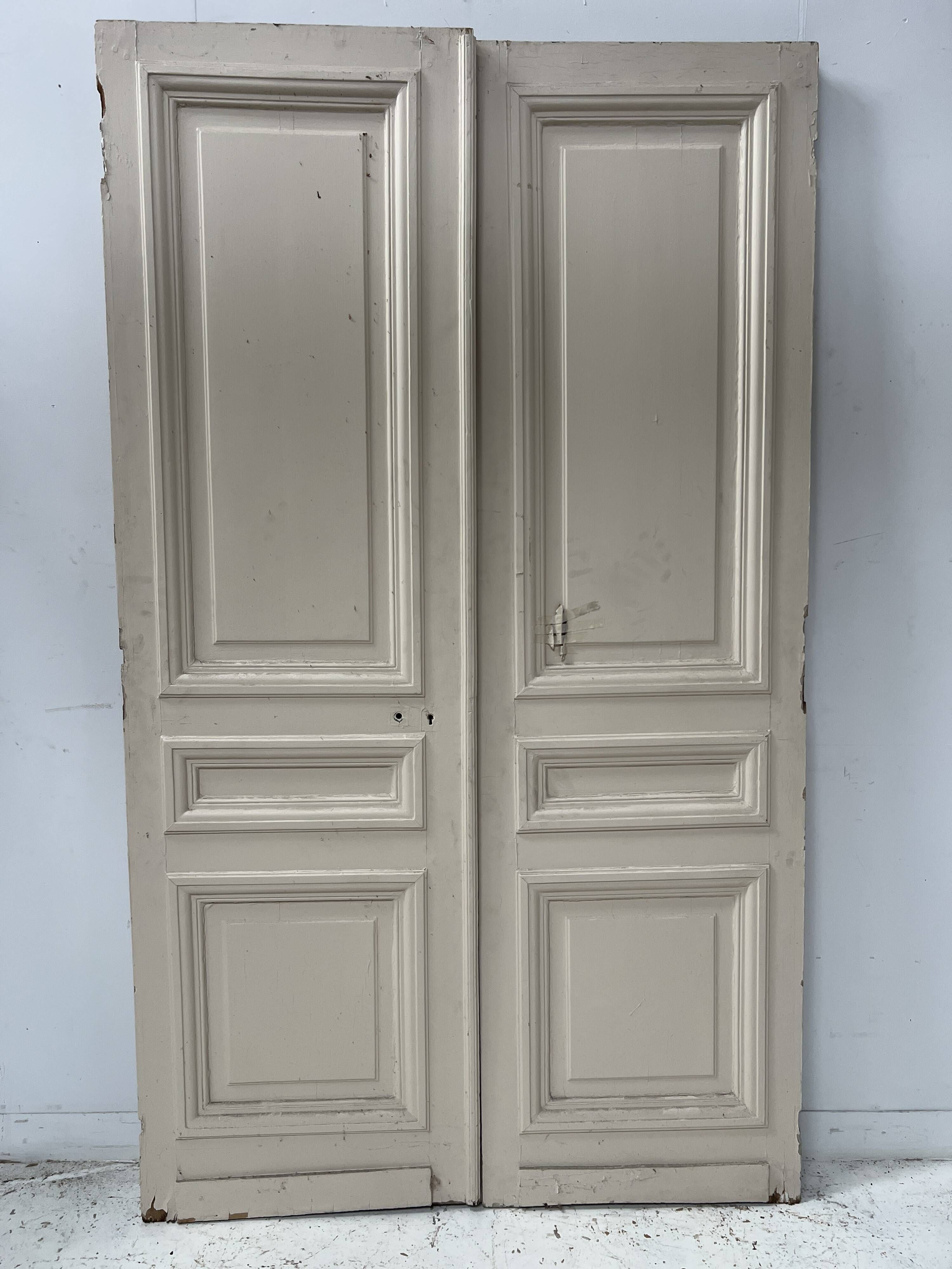 Pair of Haussmann-style double passage doors in patinated oak from the 19th century.
