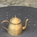 Small decorative teapot in vintage chiseled copper