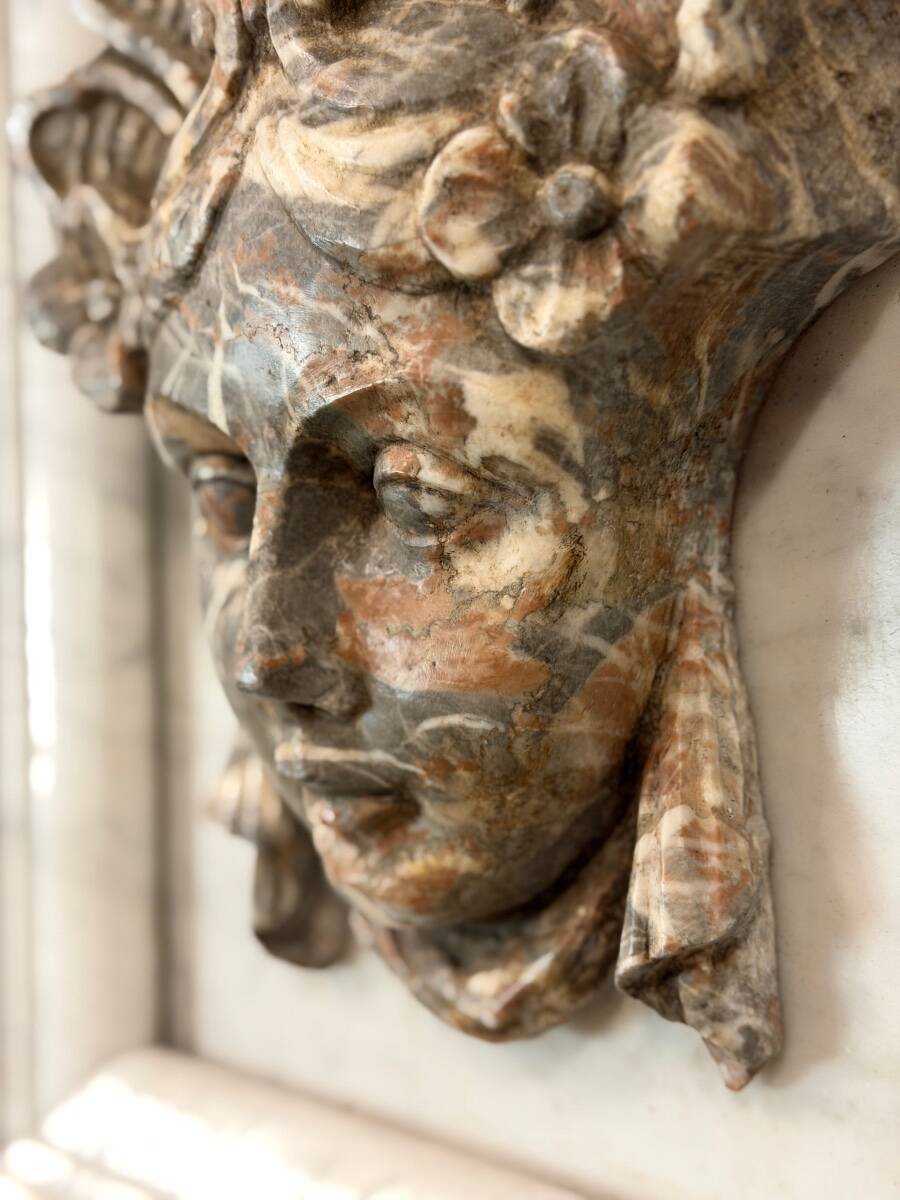Female mascaron in grey Ardennes marble from the Regency period, 18th century.