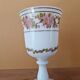 Footed glass in the shape of a chalice in white opaline with a floral decoration.