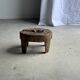 Small low circular four-legged stool in organic old teak with cut-out design H2