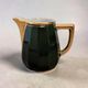 Dark green ceramic decorative jug with golden trim.