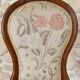 Antique Louis XVI style chair in wood and floral fabric.