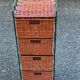 Metal chest of drawers and four woven wicker baskets