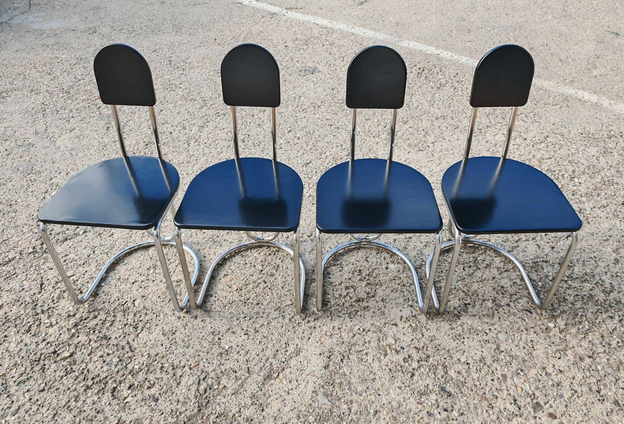 Set of 4 Bauhaus tubular steel chairs with wooden seats.