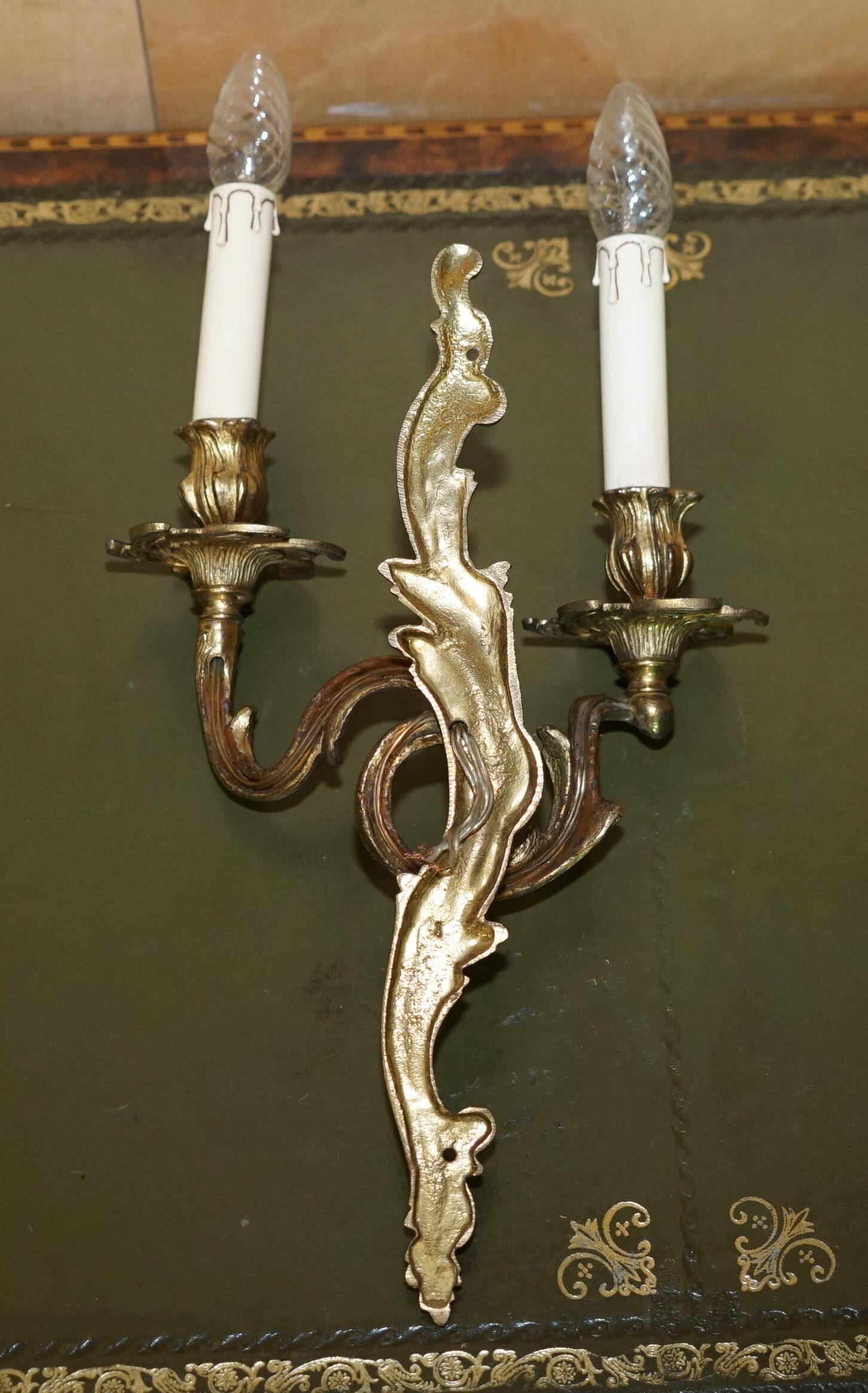 Pair of antique wall sconces from the 1920s in gilded bronze.