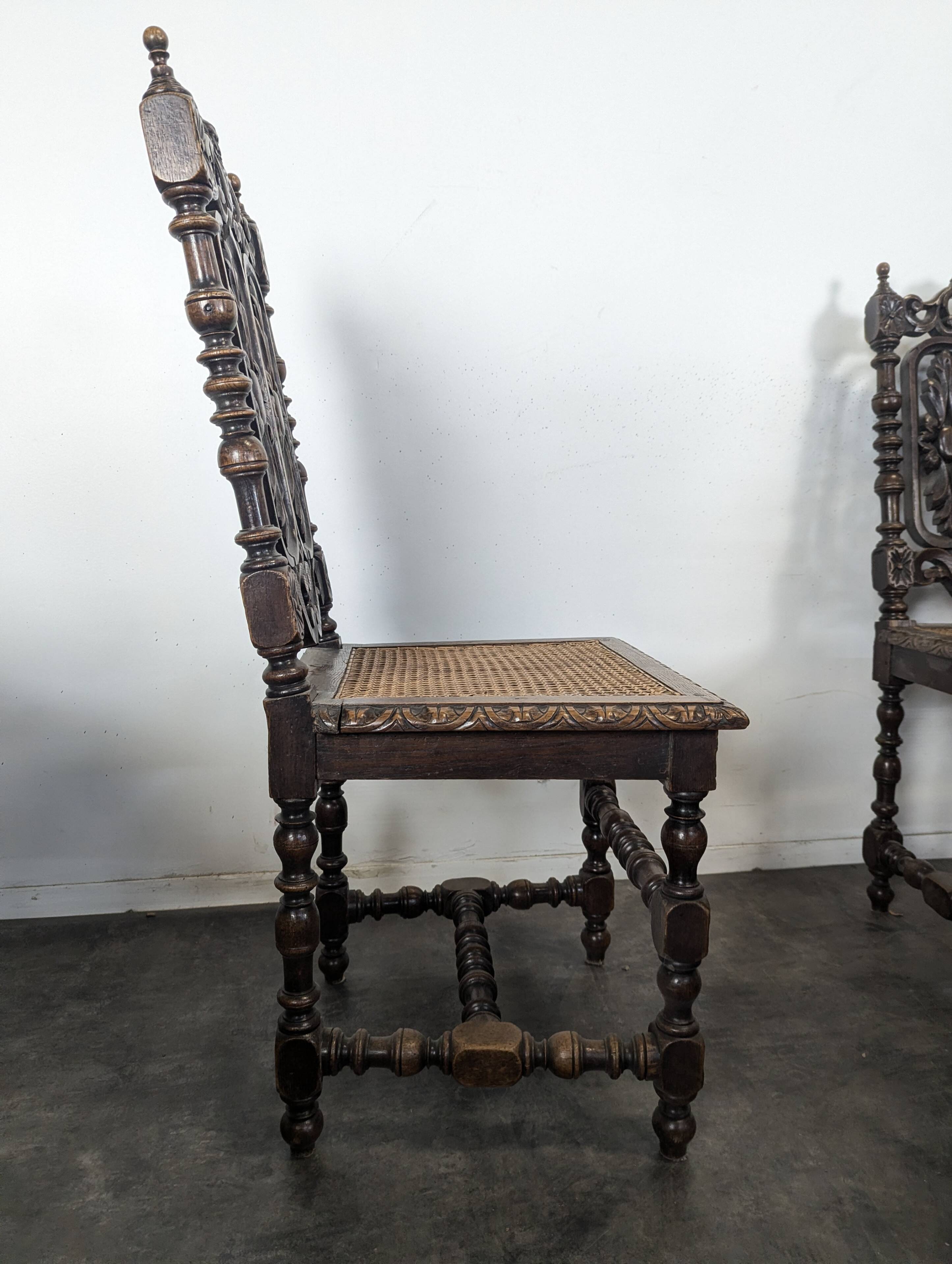 Set of 6 Henri II chairs in carved openwork oak with caned seats.