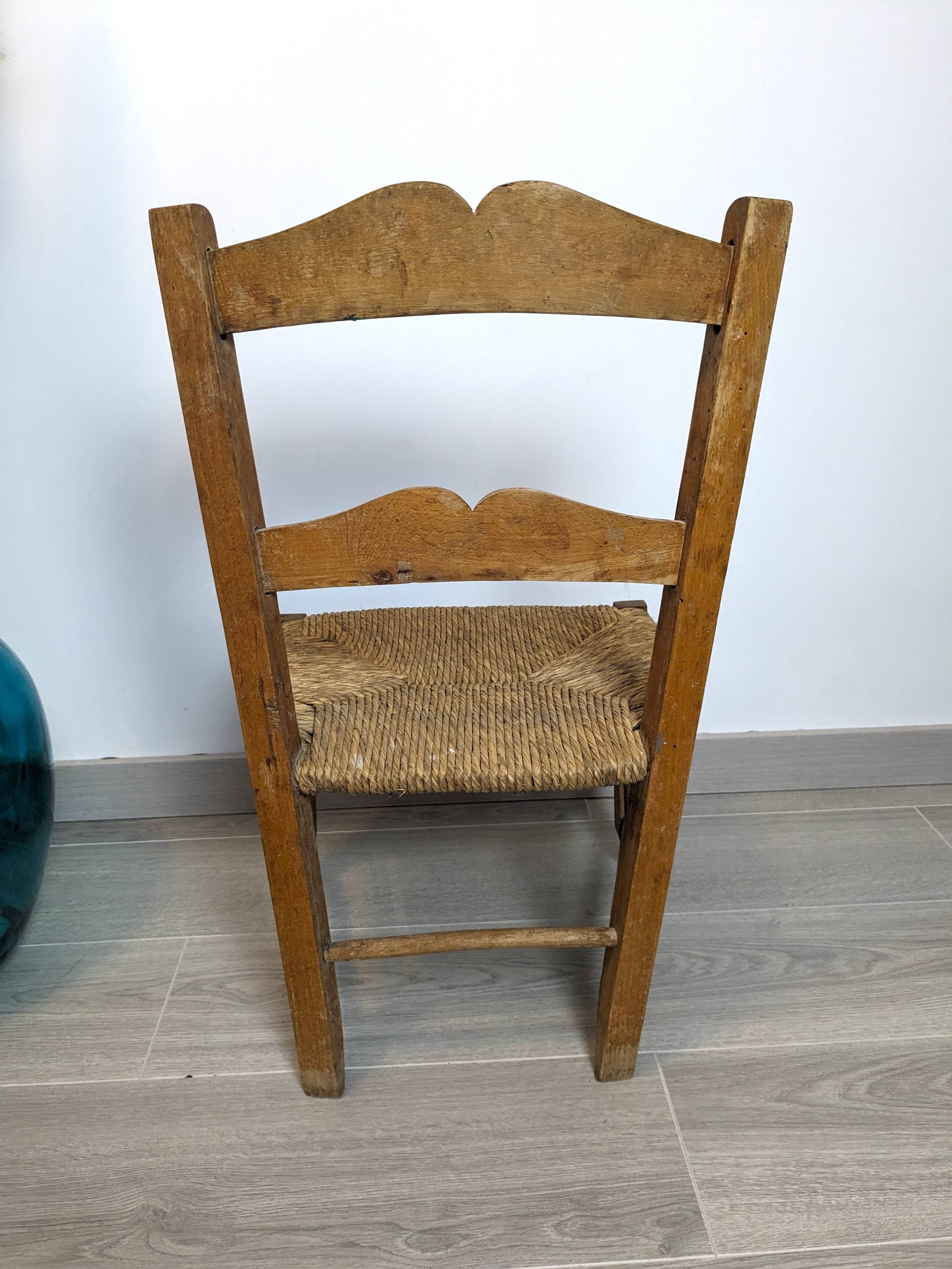 Vintage wooden and straw children's chair in a country style.