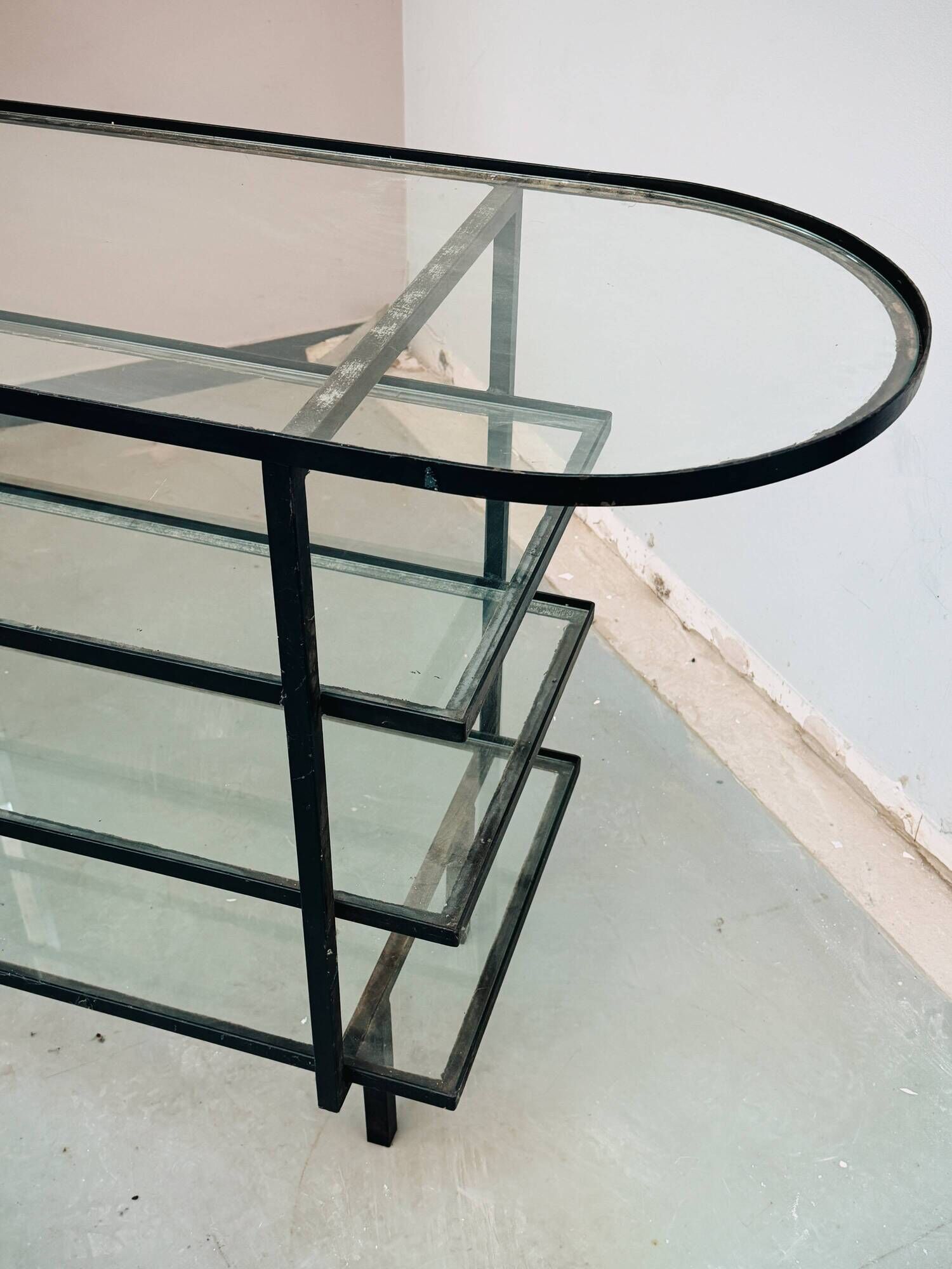 Mid-century console with glass top and metal frame.