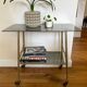 Vintage brass and smoked glass dessert trolley on wheels.