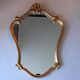 Miroir rocaille 1950 en stuc doré.
