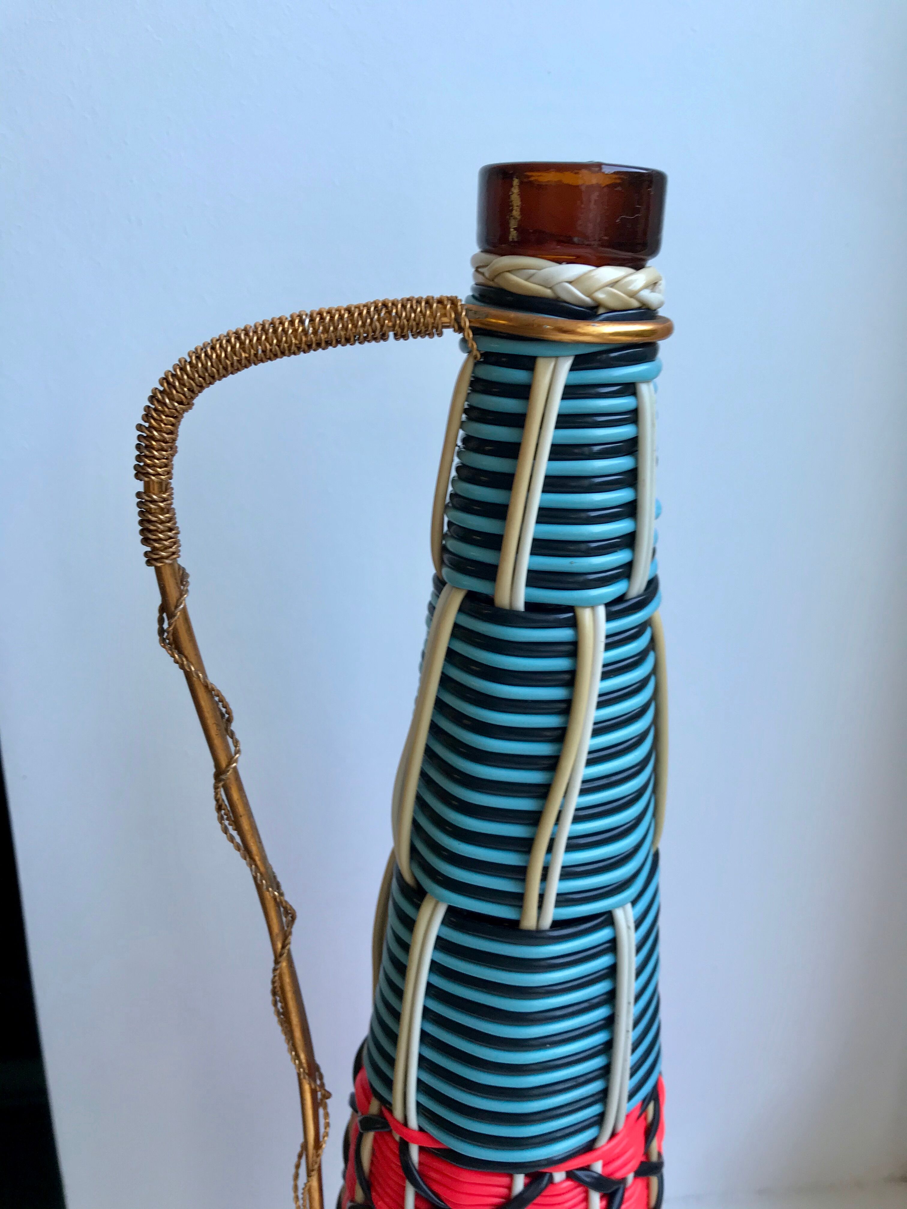 Scoubidou bottle with orange and blue and yellow brass handle 70s