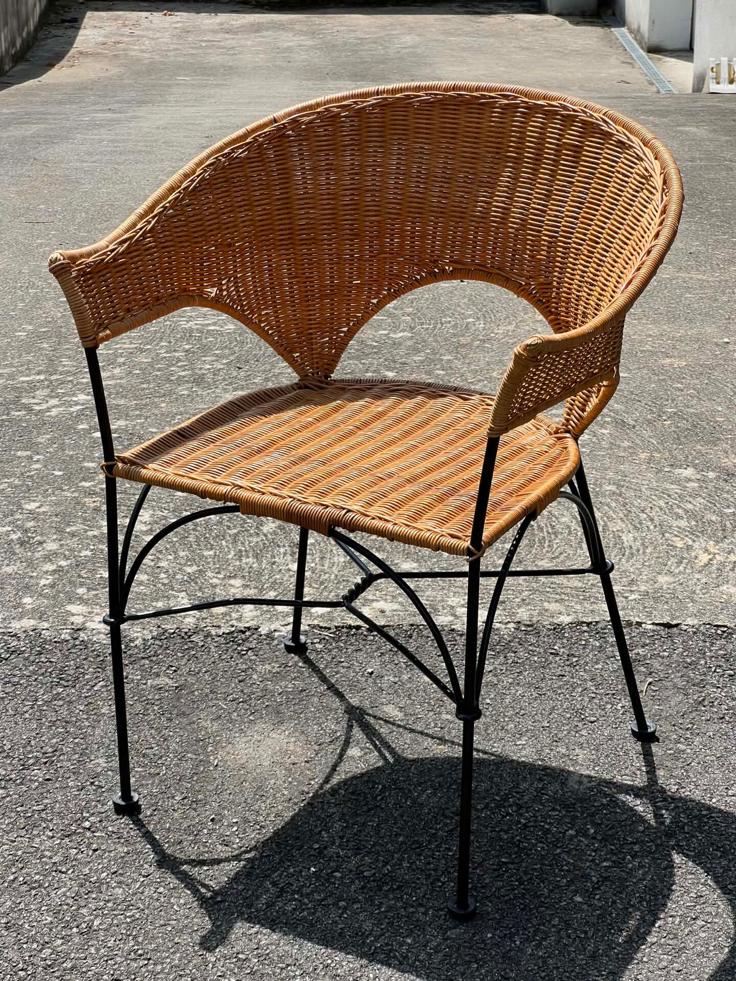 Wicker and black wrought iron armchair