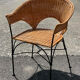 Wicker and black wrought iron armchair