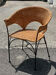 Wicker and black wrought iron armchair