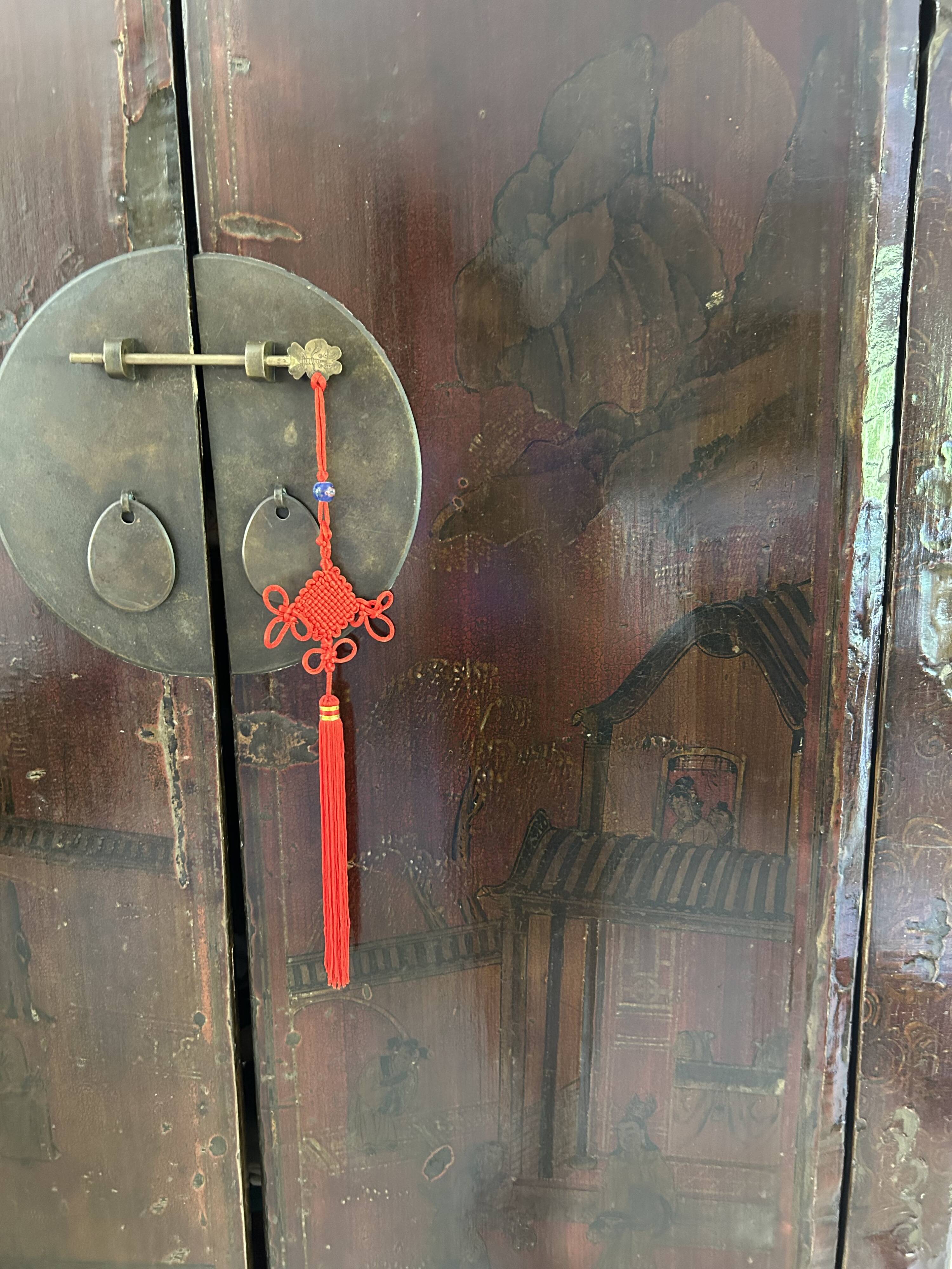 Antique Chinese wardrobe in carved elm.