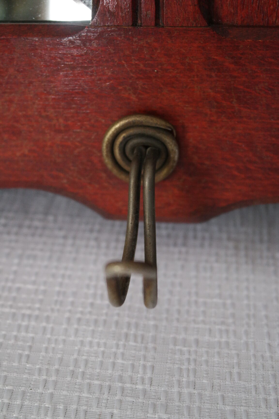 Red wooden wall-mounted coat rack and Art Deco mirror