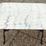 White and black oval marble table, wrought iron base