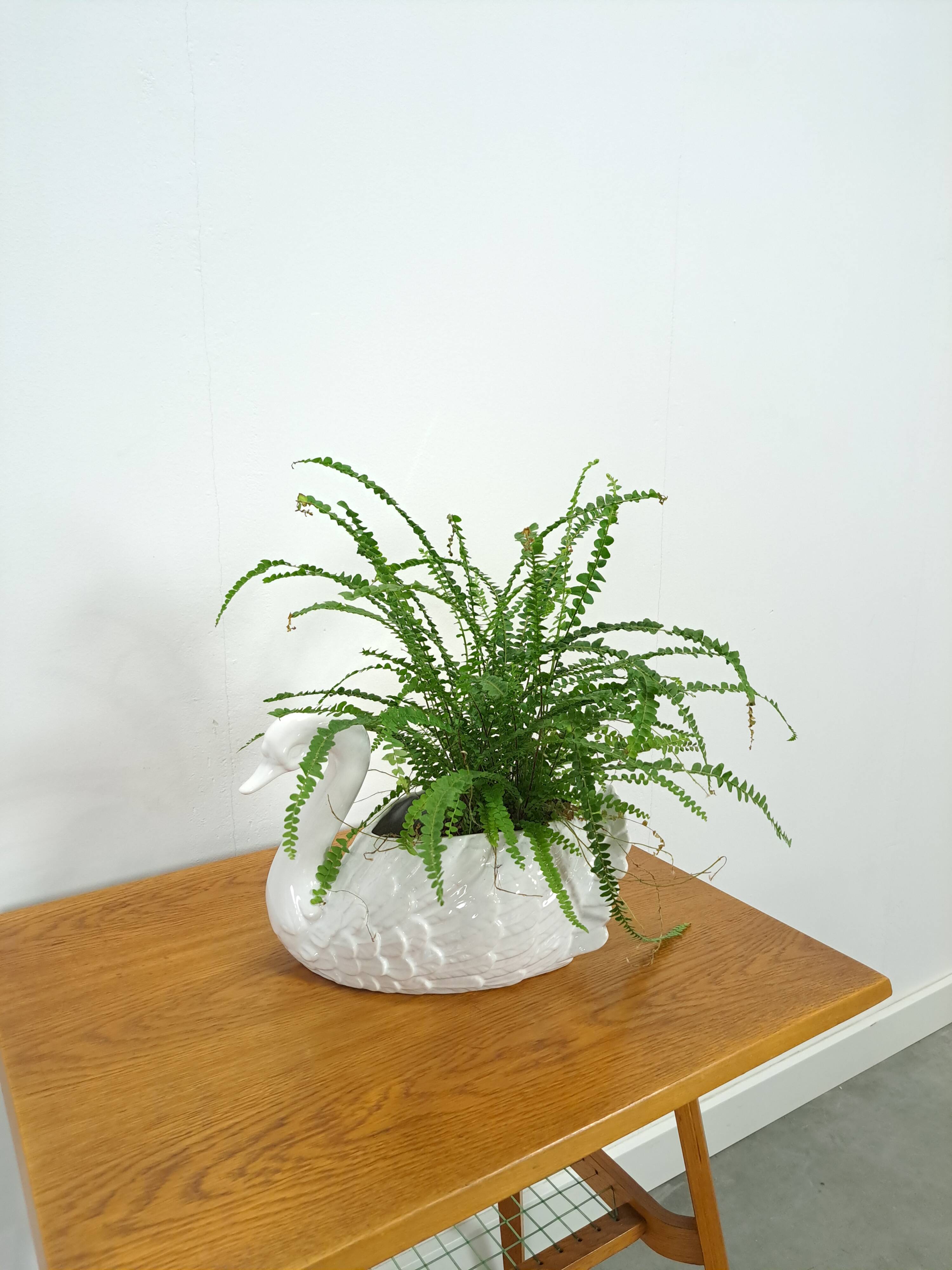 vintage porcelain flower pot in the shape of a swan