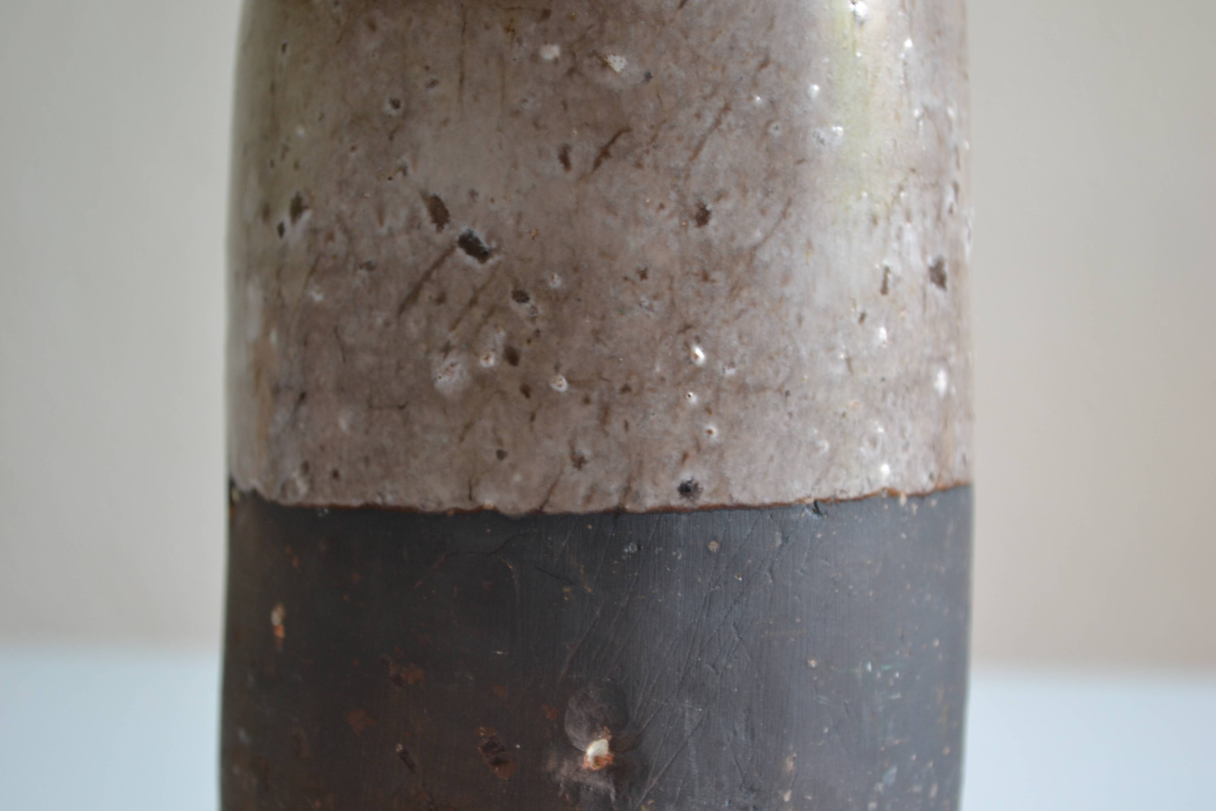 Ceramic bottle vase with a fish signature to be identified.
