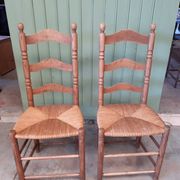 Pair of country-style straw chairs.