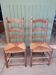 Pair of country-style straw chairs.