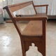 Church bench in fir tree with armrests
