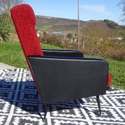 Pair of vintage armchairs in black faux leather and red fabric.