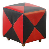 Mid-century ottoman stool in red and black faux leather with wooden legs.