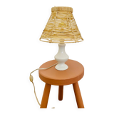White porcelain table lamp and vintage raffia lampshade