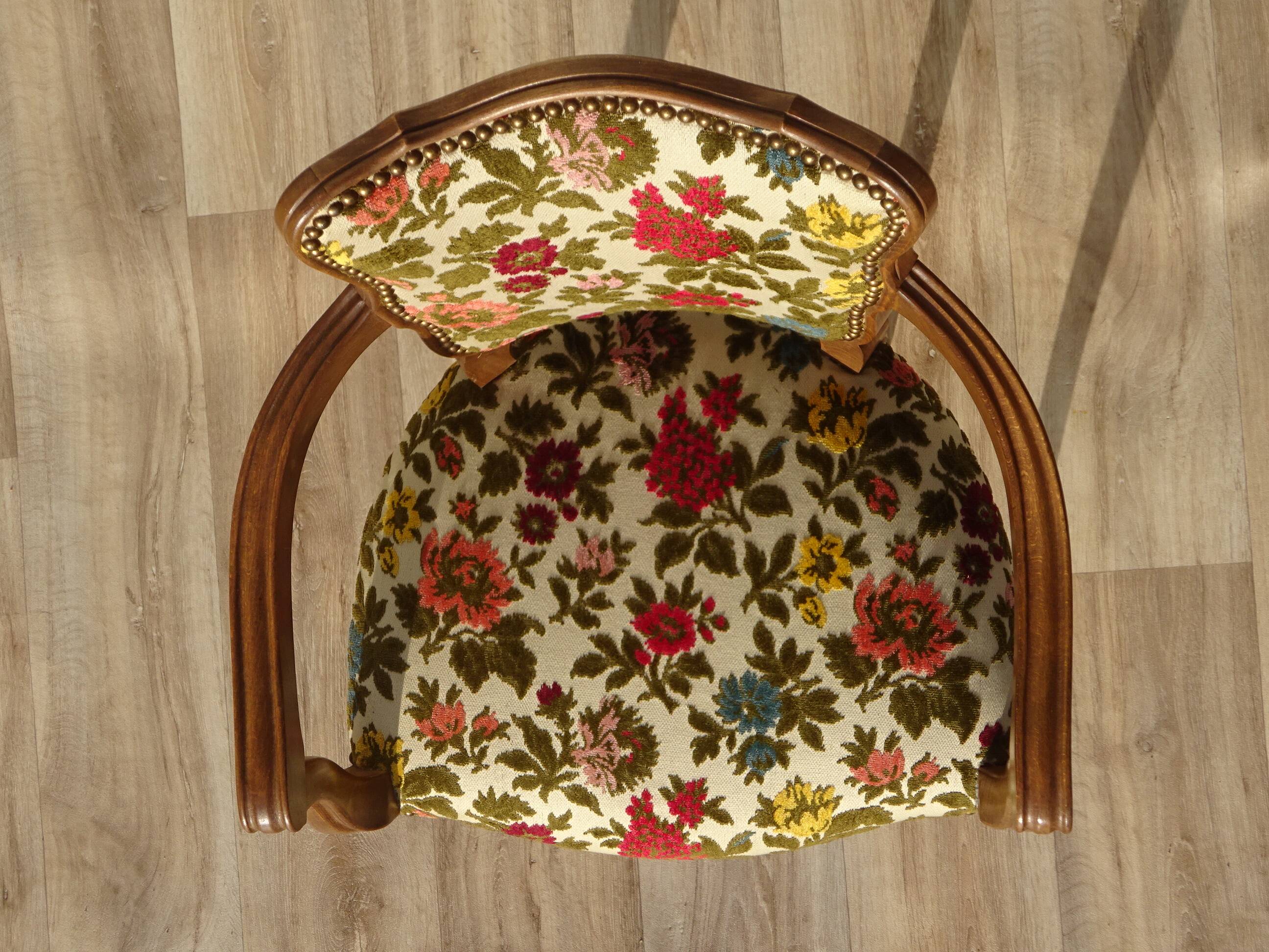 Convertible armchair with brocade fabric and floral patterns.