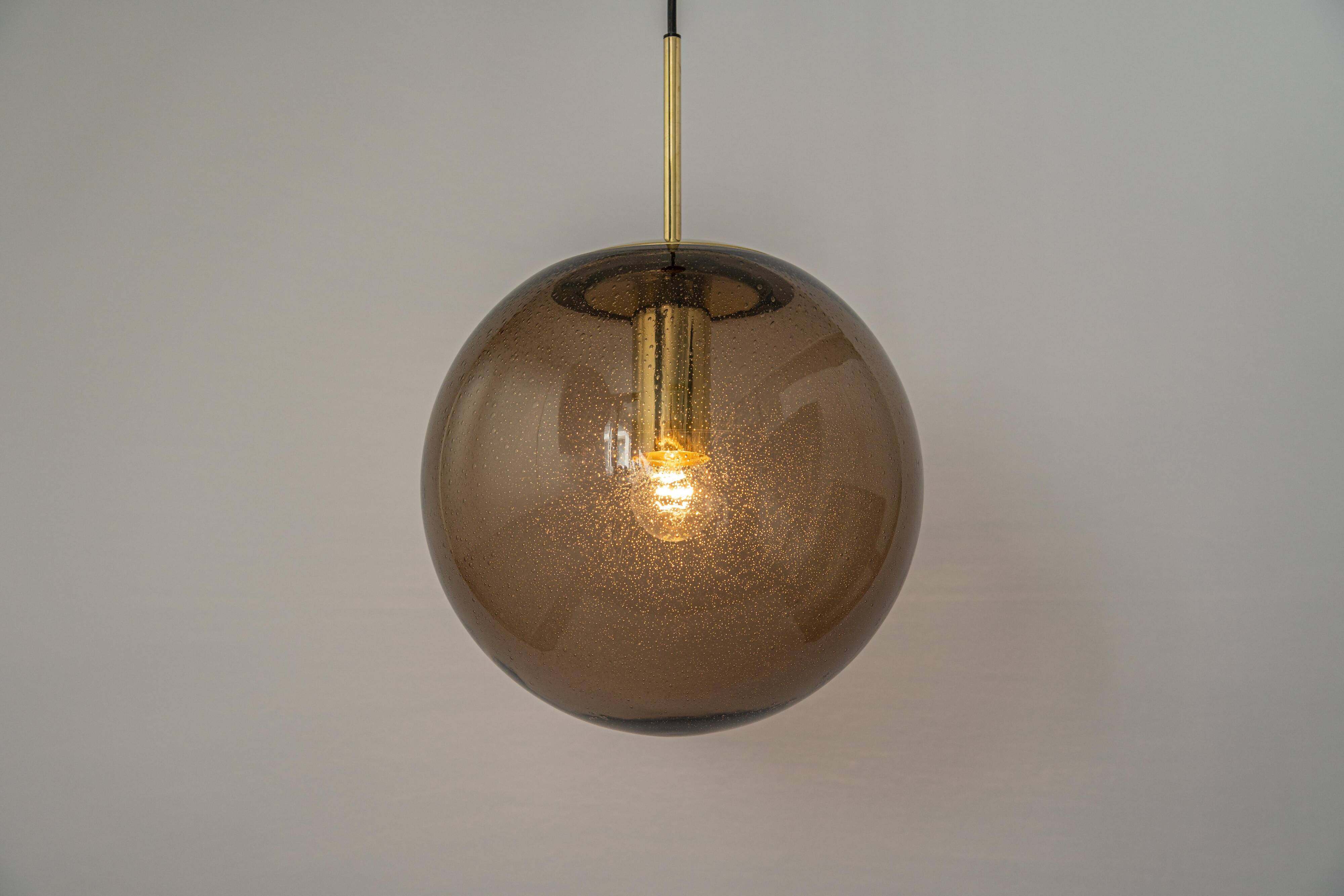 Large smoked glass ball pendant by Limburg in brass, Germany, 1970s.