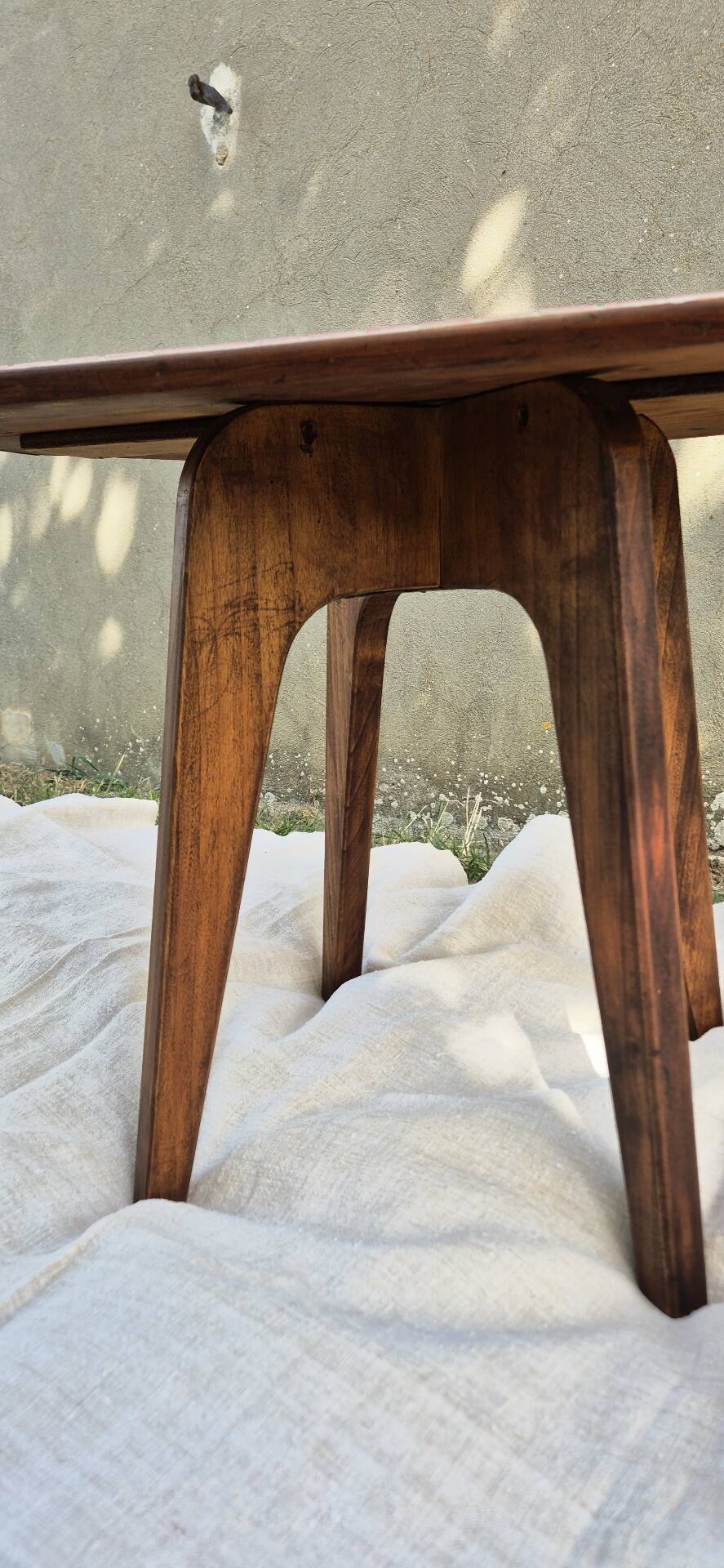 Small Scandinavian side table with wood and pink tiles, with tapered legs.