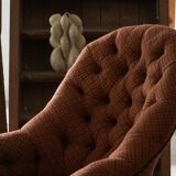 Victorian mahogany armchair, with wheels and coloured fabric, England, early 1900s.