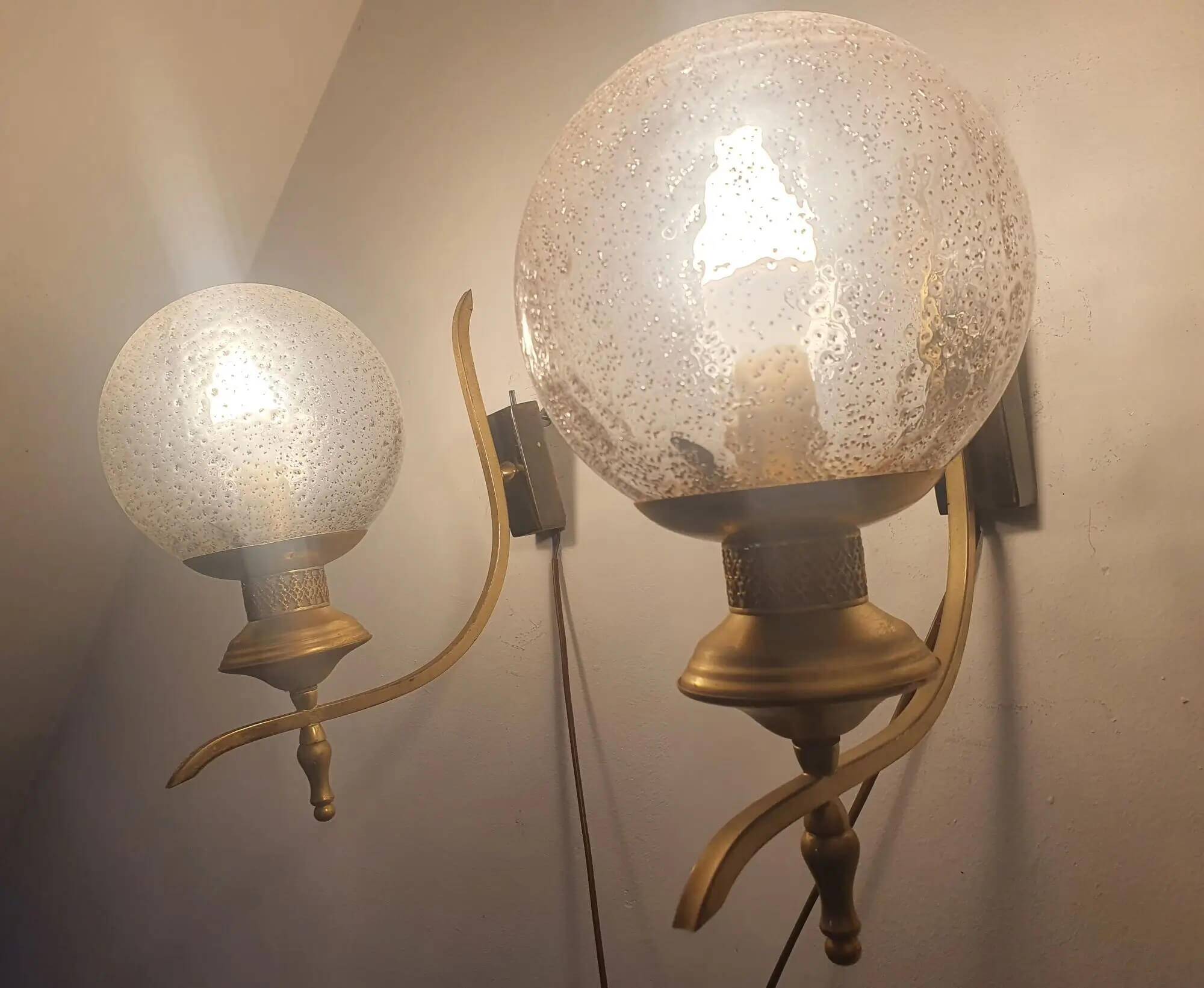Pair of vintage gold wall sconces with transparent globes