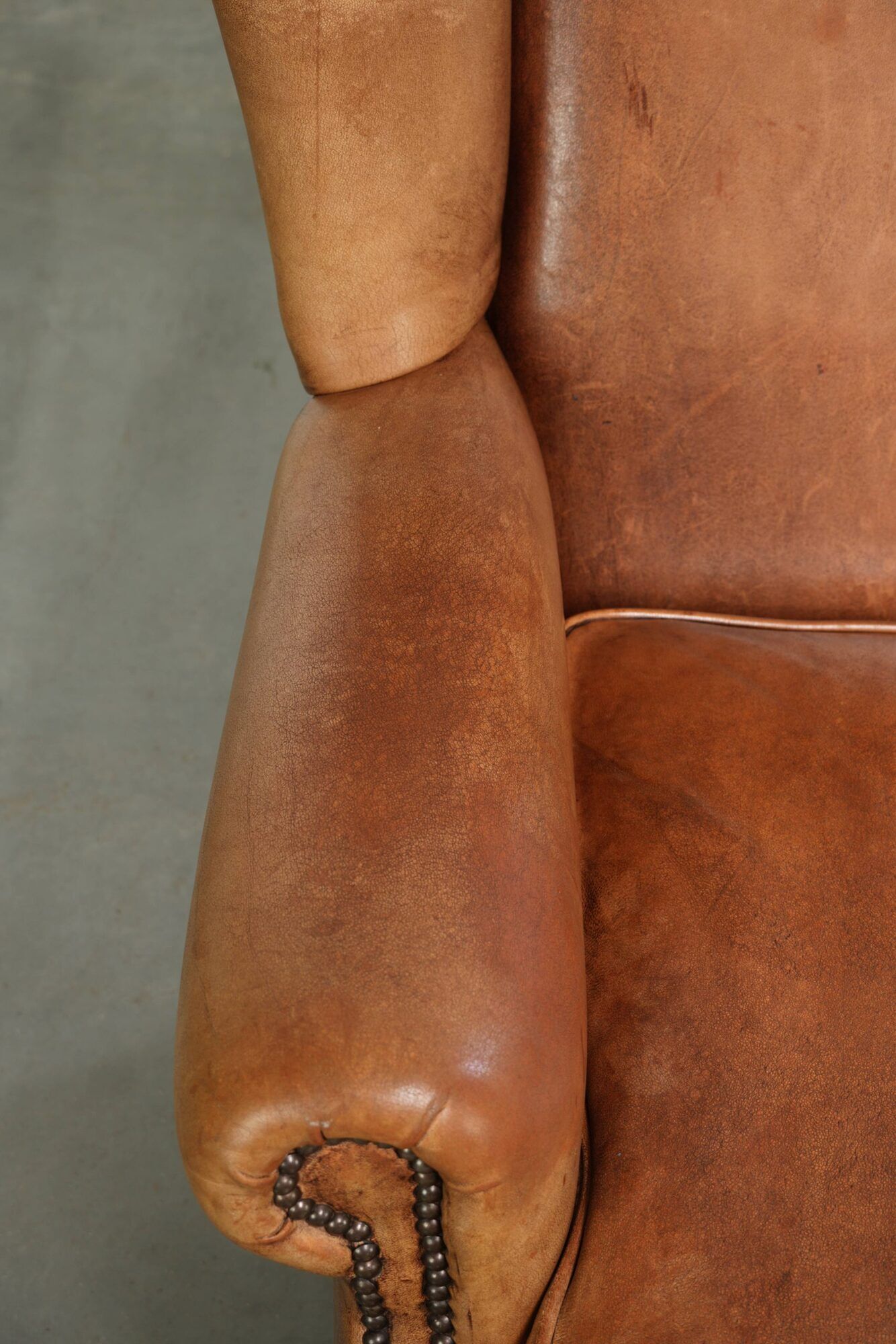 Sheepskin wingback armchair in a light cognac colour in English style