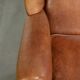 Sheepskin wingback armchair in a light cognac colour in English style